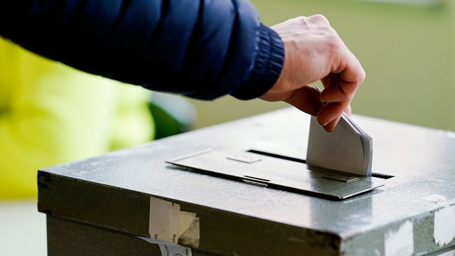 A voter turns in her ballot at a polling station in Mannheim, Germany, on March 14. About two-thirds of adults in Germany say it is important to make voting compulsory for all citizens. (Uwe Anspach/picture alliance via Getty Images)
