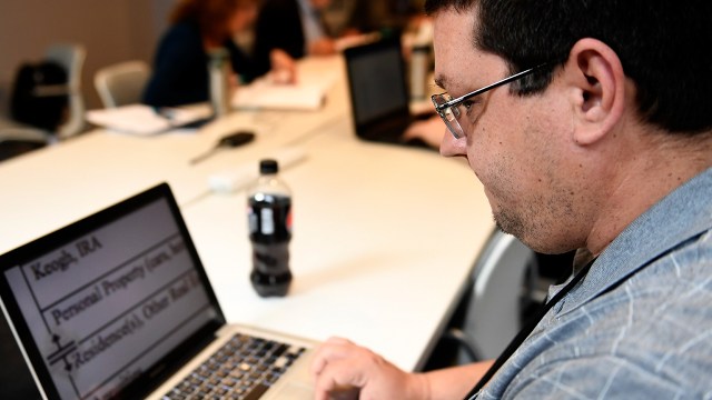 A man reads magnified text on his computer during a session of a vocational program for the visually impaired in Denver.