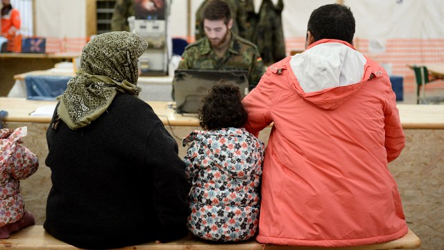 Syrian refugees wait to register at the Erding Air Base in Germany on Jan. 31, 2016. (Andreas Gebert/dpa/AFP via Getty Images)