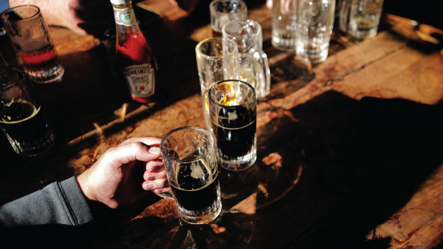 Customers with beers at McSorley's Old Ale House in New York in February 2024. (Charly Triballeau/AFP via Getty Images)